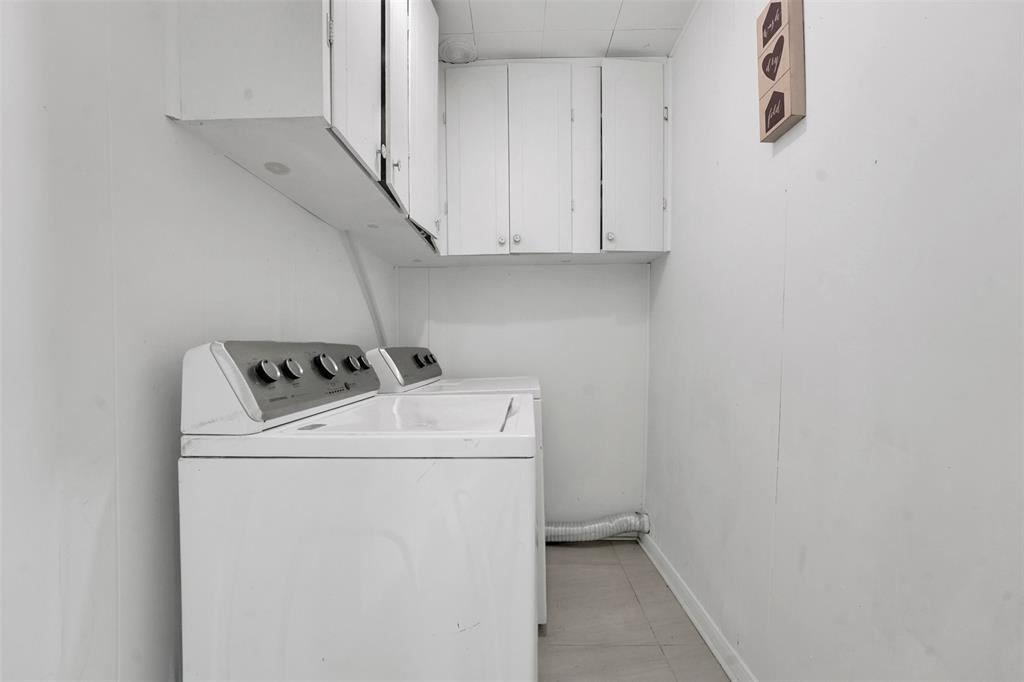 10525 Post Oak Bend Lane Wills Point, TX 75169 - Photo 34 of 40 Laundry area featuring cabinet space, washing machine and clothes dryer, and light tile patterned floors