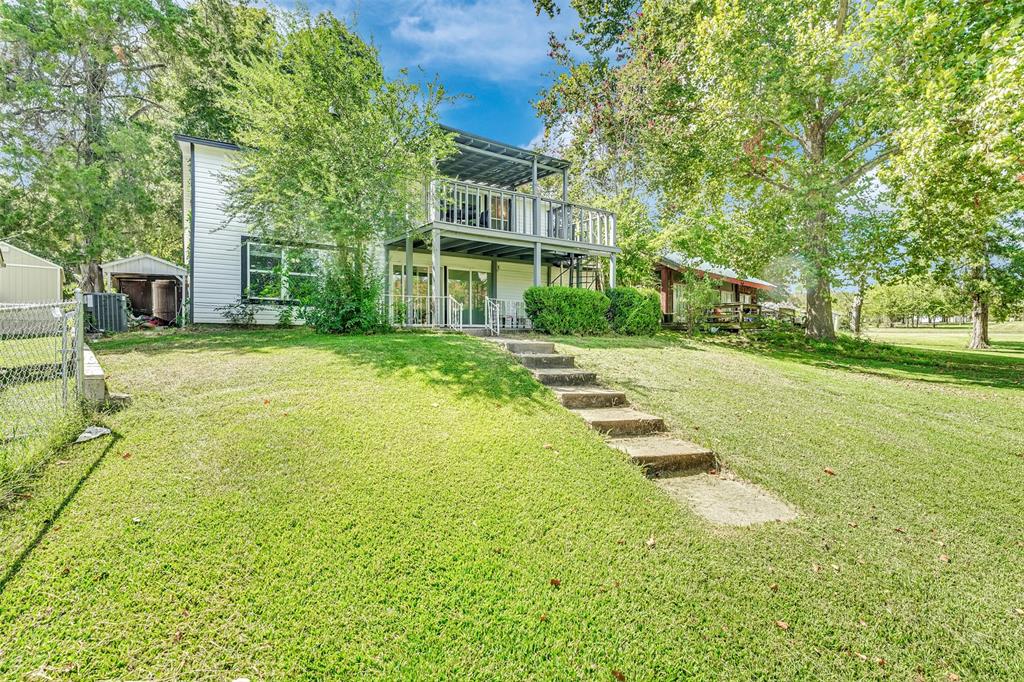 10525 Post Oak Bend Lane Wills Point, TX 75169 - Photo 37 of 40 Back of house featuring a yard and an outdoor structure