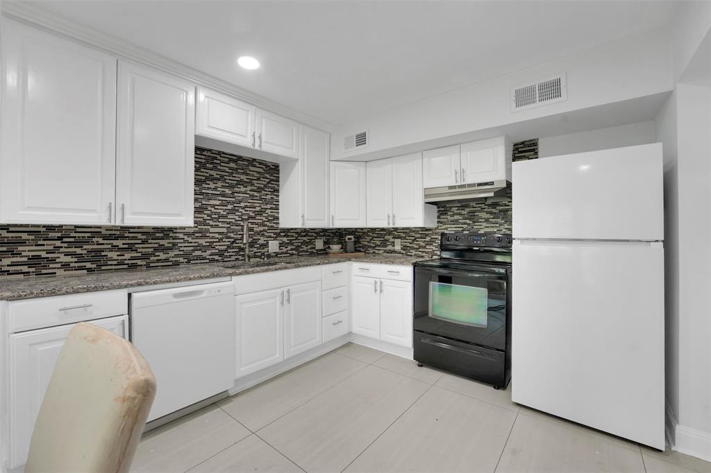 10525 Post Oak Bend Lane Wills Point, TX 75169 - Photo 8 of 40 Kitchen featuring white appliances, light tile patterned floors, white cabinetry, tasteful backsplash, and dark stone countertops