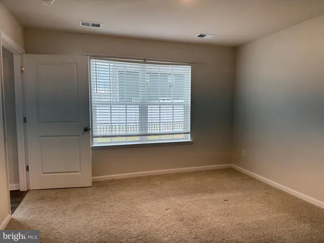 a view of an empty room and closet