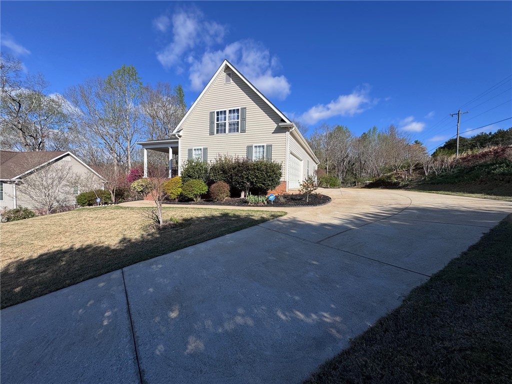 102 Brookstone Way Central, SC 29630 - Photo 2 of 50 This inviting home offers classic appeal with a welcoming front porch and attached garage.