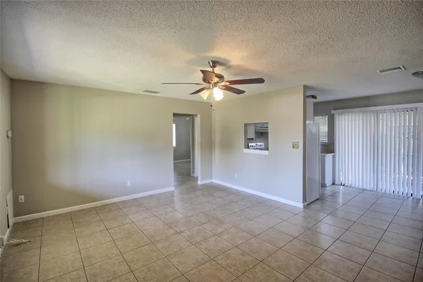 an empty room and chandelier fan