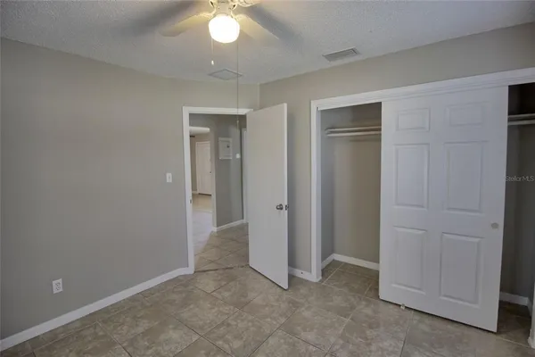 an empty room with closet area