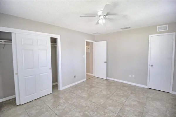 a view of an empty room with a ceiling fan
