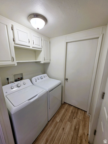 1604 180 East Tooele, UT 84074 - Photo 13 of 16 Dedicated laundry area featuring white cabinetry with ample storage, a built-in shelf, and wood-finish flooring