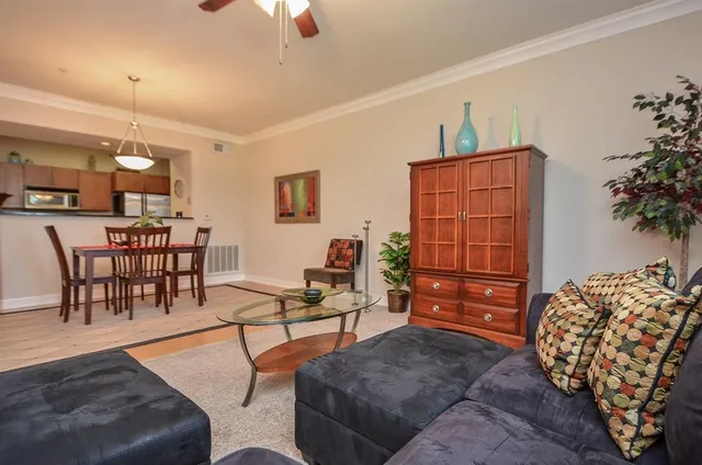 a living room with furniture and wooden floor
