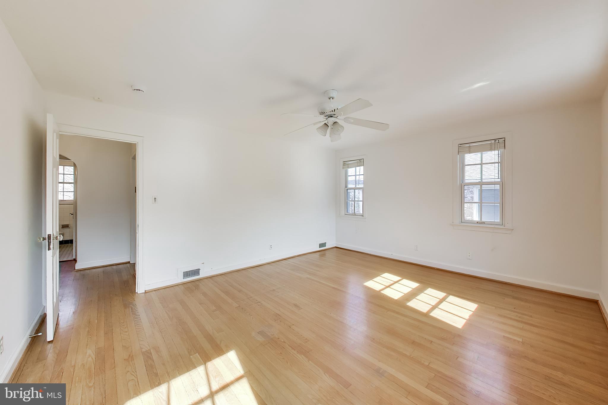 5138 Nebraska Avenue Northwest Washington, DC 20008 - Photo 18 of 39 an empty room with wooden floor and windows