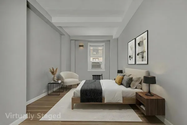 a bedroom with two beds and a lamp