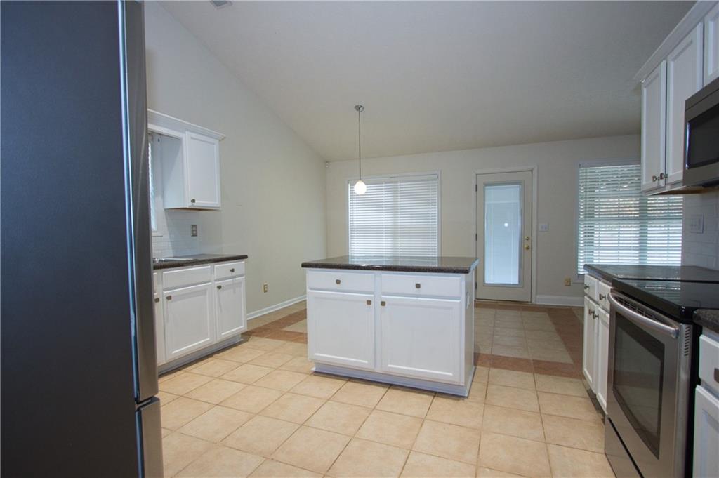 1481 Beckley Pointe Lawrenceville, GA 30043 - Photo 13 of 45 a kitchen with granite countertop white cabinets and appliances