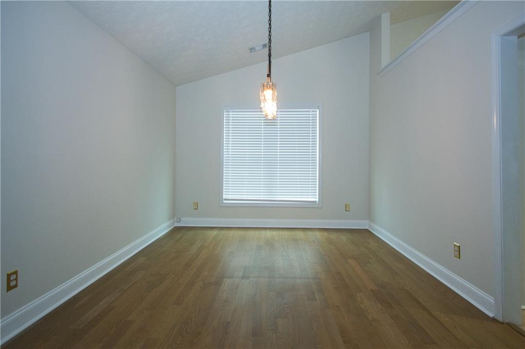 1481 Beckley Pointe Lawrenceville, GA 30043 - Photo 14 of 45 a view of empty room with wooden floor and fan