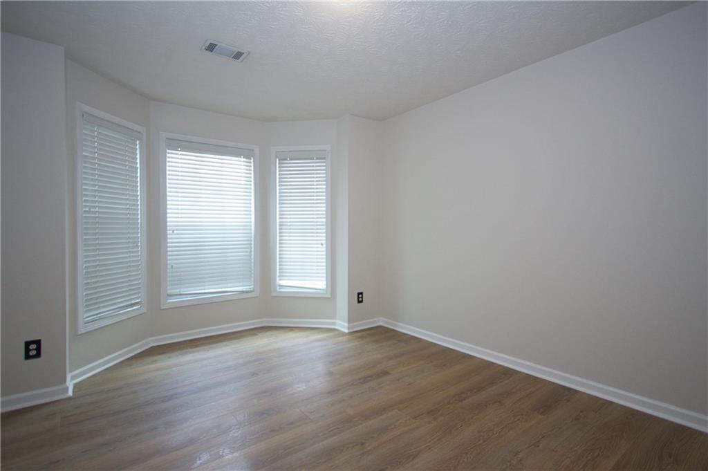 1481 Beckley Pointe Lawrenceville, GA 30043 - Photo 15 of 45 an empty room with wooden floor and windows
