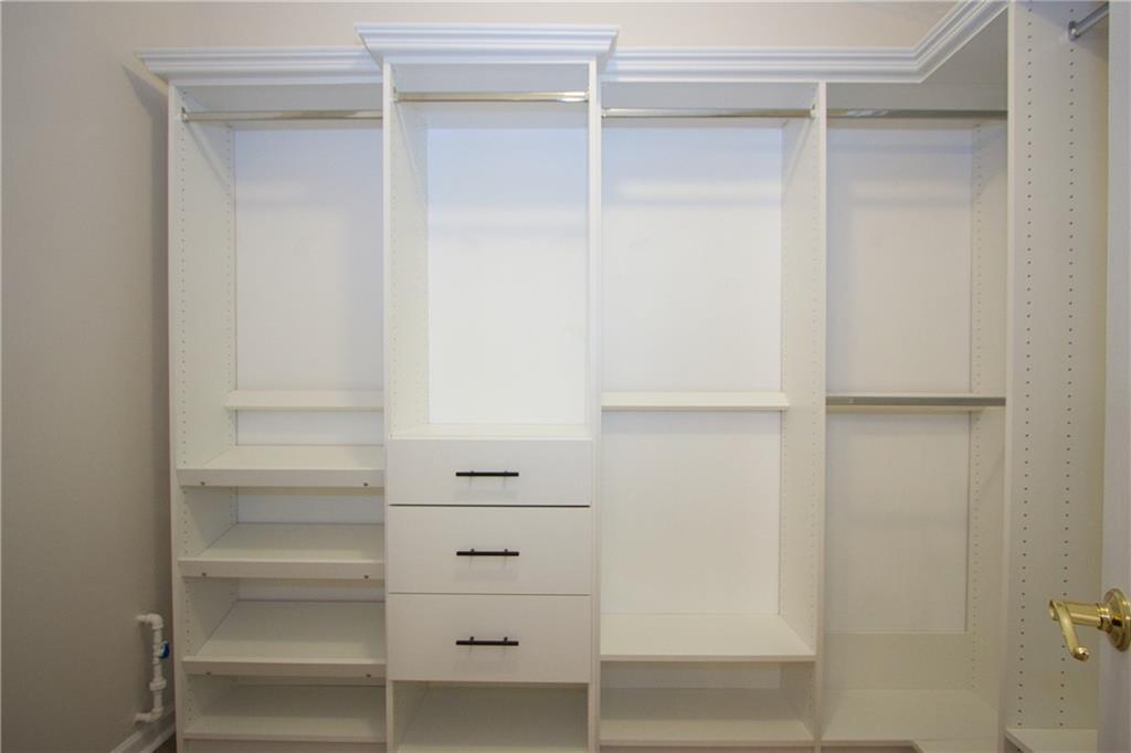 1481 Beckley Pointe Lawrenceville, GA 30043 - Photo 16 of 45 a view of walk in closet with empty racks