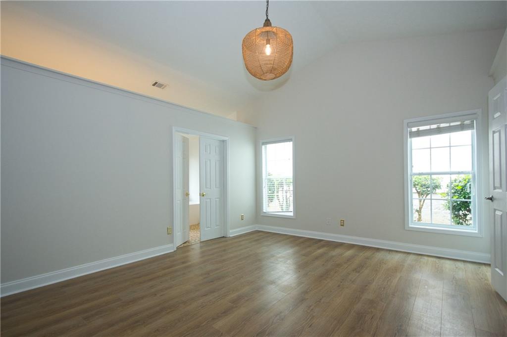 1481 Beckley Pointe Lawrenceville, GA 30043 - Photo 17 of 45 an empty room with wooden floor and windows