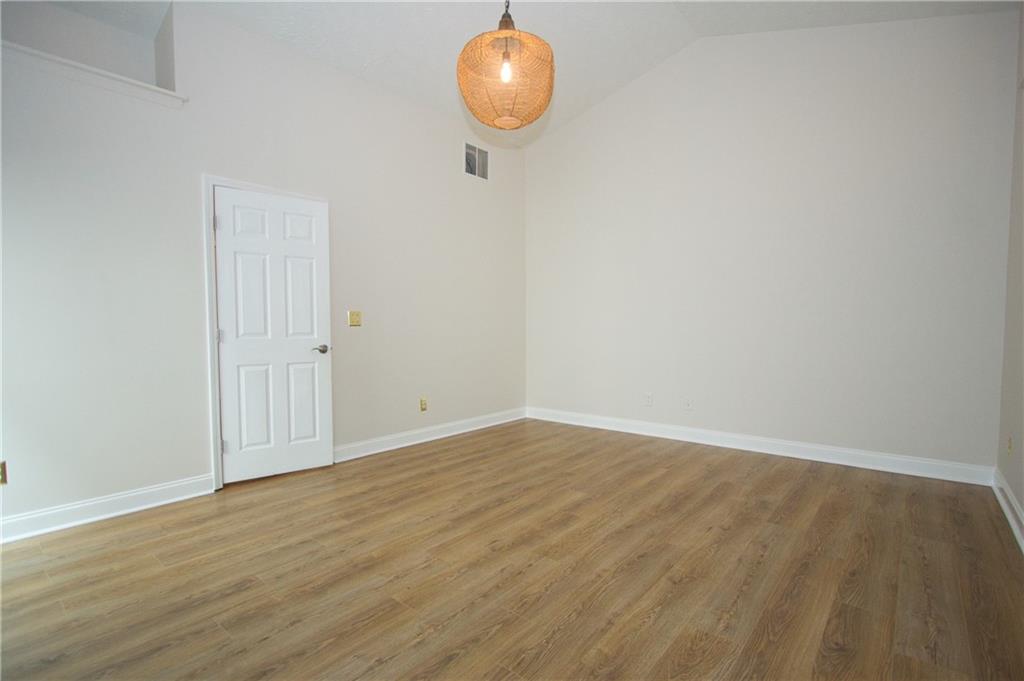 1481 Beckley Pointe Lawrenceville, GA 30043 - Photo 18 of 45 a view of an empty room with wooden floor