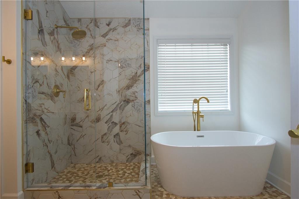 1481 Beckley Pointe Lawrenceville, GA 30043 - Photo 22 of 45 a bathroom with a bathtub and shower