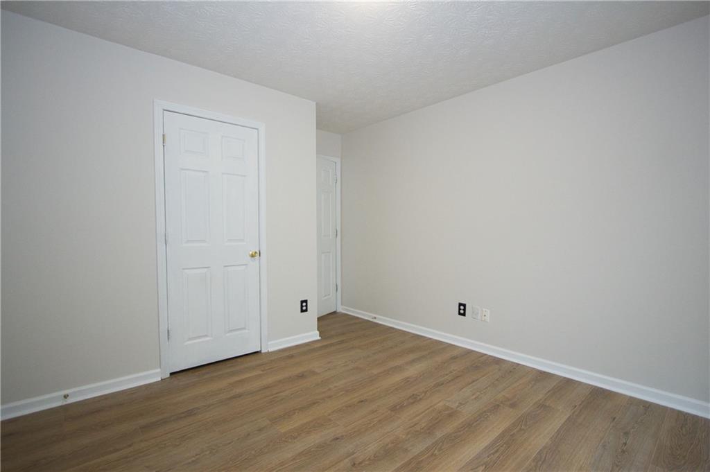 1481 Beckley Pointe Lawrenceville, GA 30043 - Photo 28 of 45 a view of an empty room with wooden floor