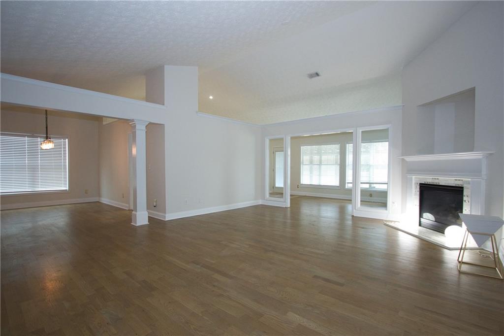 1481 Beckley Pointe Lawrenceville, GA 30043 - Photo 4 of 45 a view of a livingroom with wooden floor and a fireplace