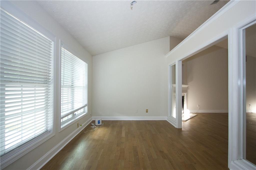 1481 Beckley Pointe Lawrenceville, GA 30043 - Photo 5 of 45 an empty room with wooden floor and windows