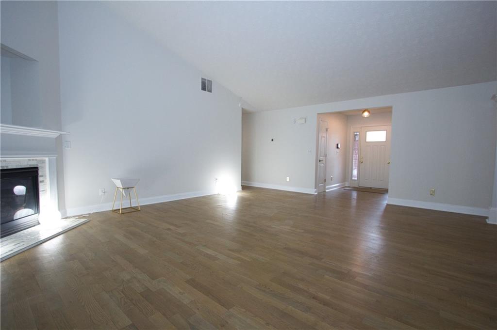 1481 Beckley Pointe Lawrenceville, GA 30043 - Photo 6 of 45 a view of a livingroom with wooden floor and a fireplace