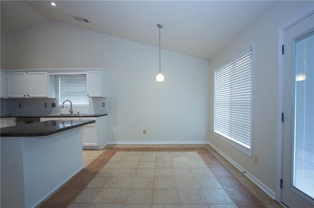 1481 Beckley Pointe Lawrenceville, GA 30043 - Photo 10 of 45 a kitchen with granite countertop sink and cabinets