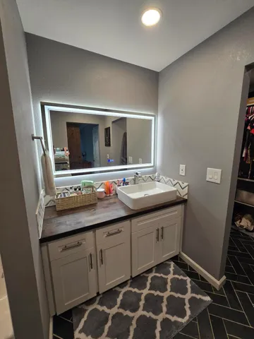 a bathroom with a sink and a mirror