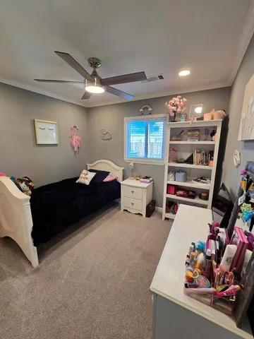 a living room with furniture a window and a flat screen tv