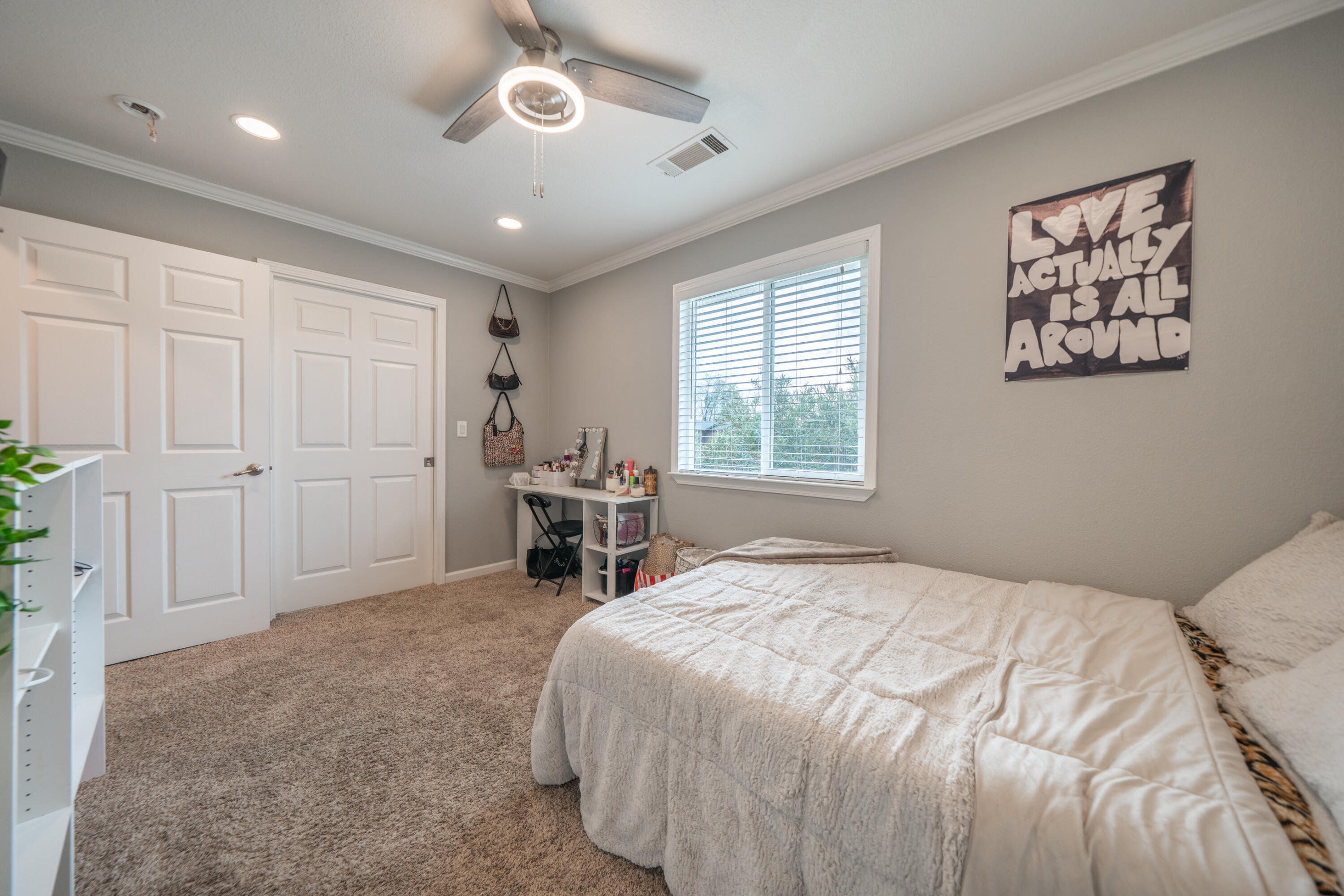 1070 Dara Court Redding, CA 96003 - Photo 23 of 66 a spacious bedroom with a bed and a table in it