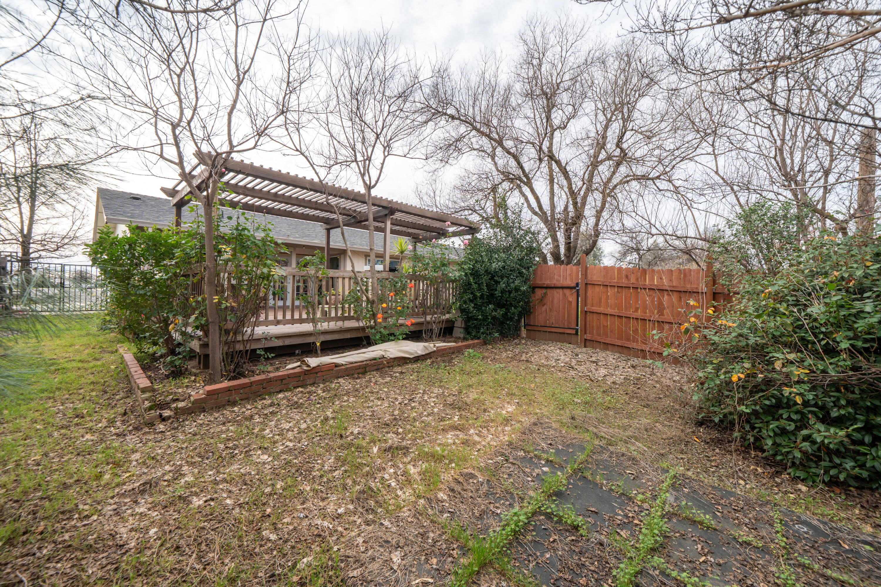 1070 Dara Court Redding, CA 96003 - Photo 49 of 66 a backyard of a house with barbeque oven and trees