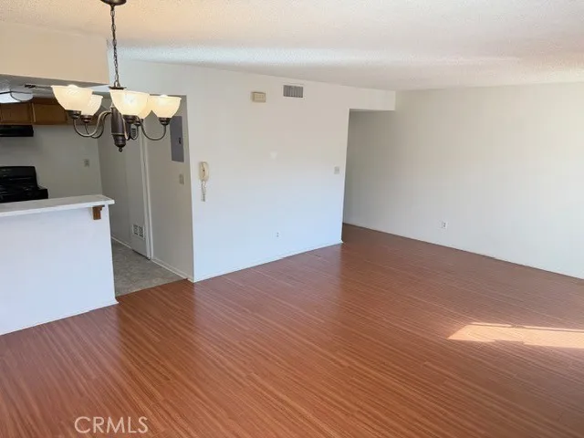 a view of a kitchen with a dishwasher and wooden floor
