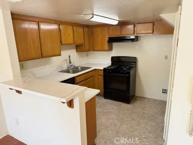 a kitchen with a sink a stove and cabinets