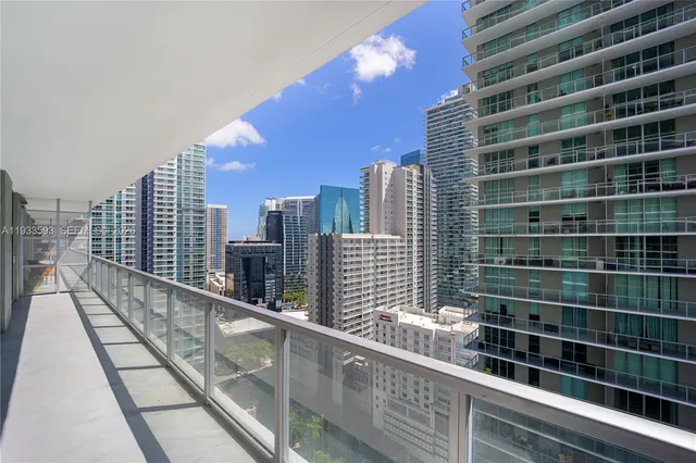 a view of a balcony with wooden floor and fence