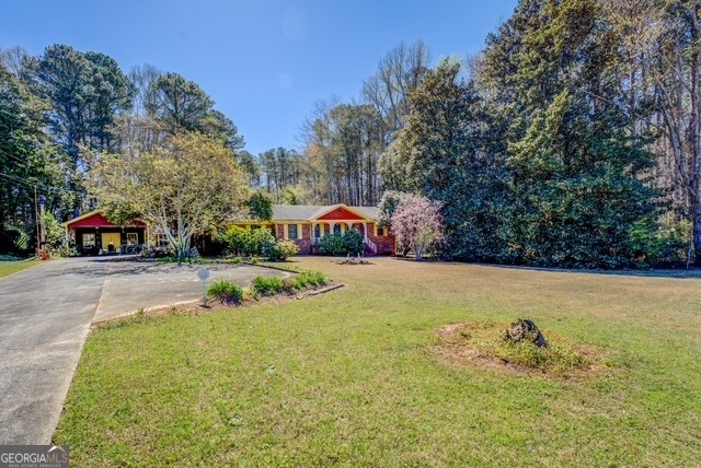 2218 Young Road Stone Mountain, GA 30088 - Photo 20 of 23 a street view with tall trees