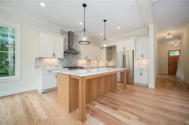 a kitchen with stainless steel appliances a refrigerator and a stove