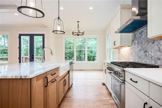 a kitchen with stainless steel appliances granite countertop a stove refrigerator and cabinets