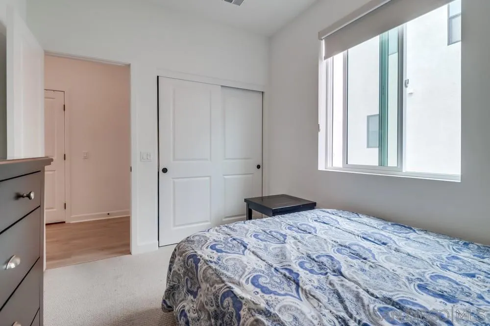 2408 Cascalote Loop San Diego, CA 92154 - Photo 12 of 50 a bedroom with a bed and a window