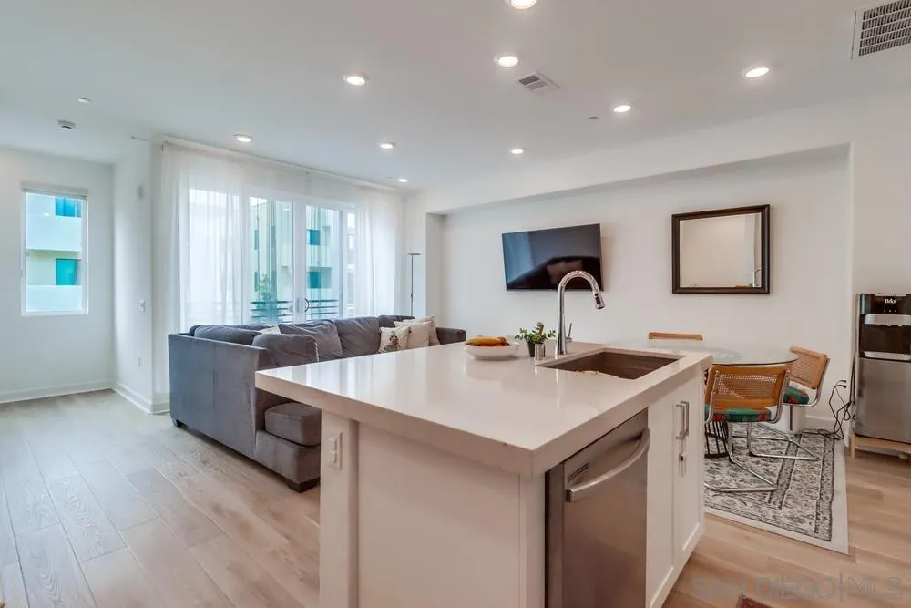 2408 Cascalote Loop San Diego, CA 92154 - Photo 17 of 50 a kitchen with a sink and chairs