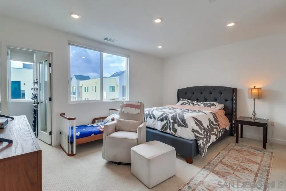 2408 Cascalote Loop San Diego, CA 92154 - Photo 30 of 50 a bedroom with a bed and a couch