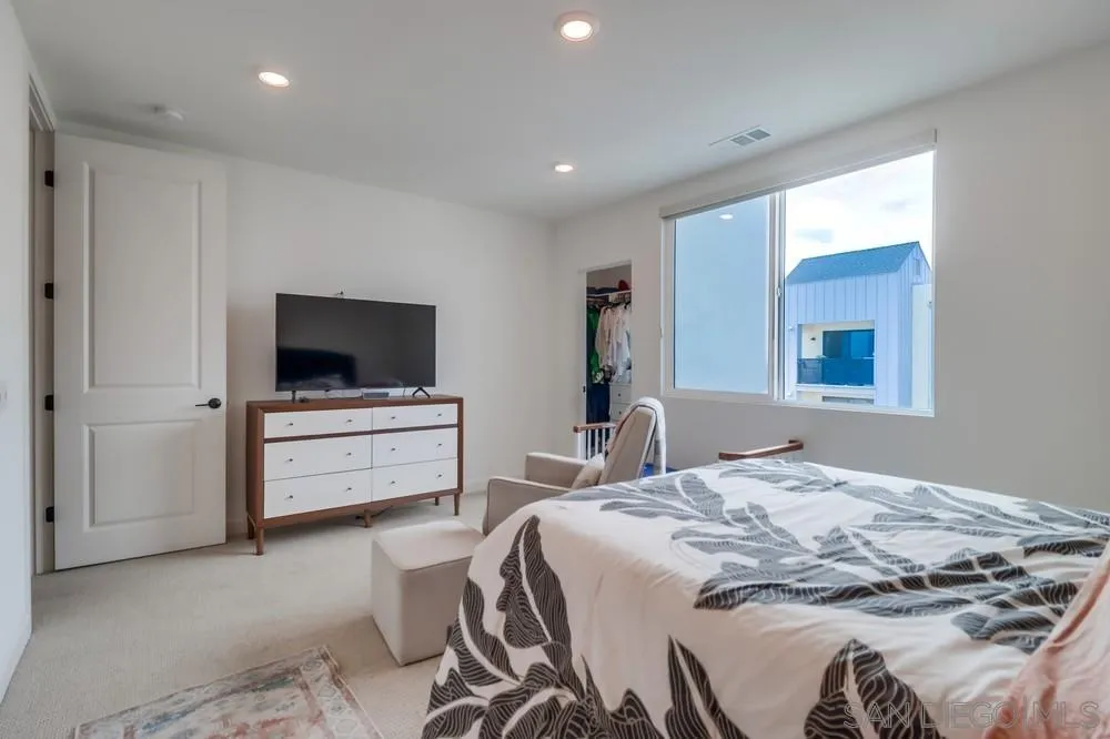2408 Cascalote Loop San Diego, CA 92154 - Photo 32 of 50 a bedroom with a bed and a flat screen tv