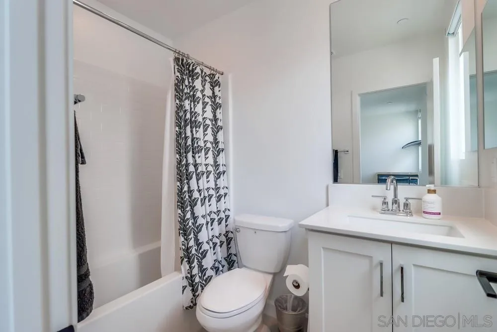 2408 Cascalote Loop San Diego, CA 92154 - Photo 36 of 50 a bathroom with a sink a toilet a shower and a mirror