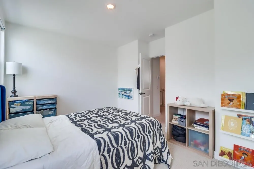 2408 Cascalote Loop San Diego, CA 92154 - Photo 38 of 50 a bedroom with a bed and a book shelf