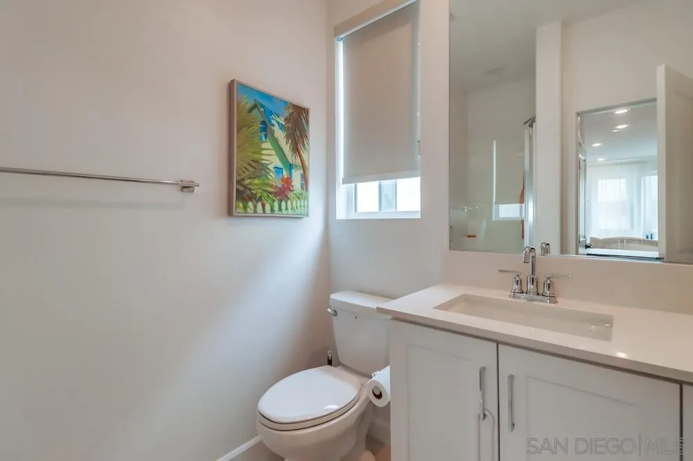 2408 Cascalote Loop San Diego, CA 92154 - Photo 9 of 50 a bathroom with a toilet a sink and mirror