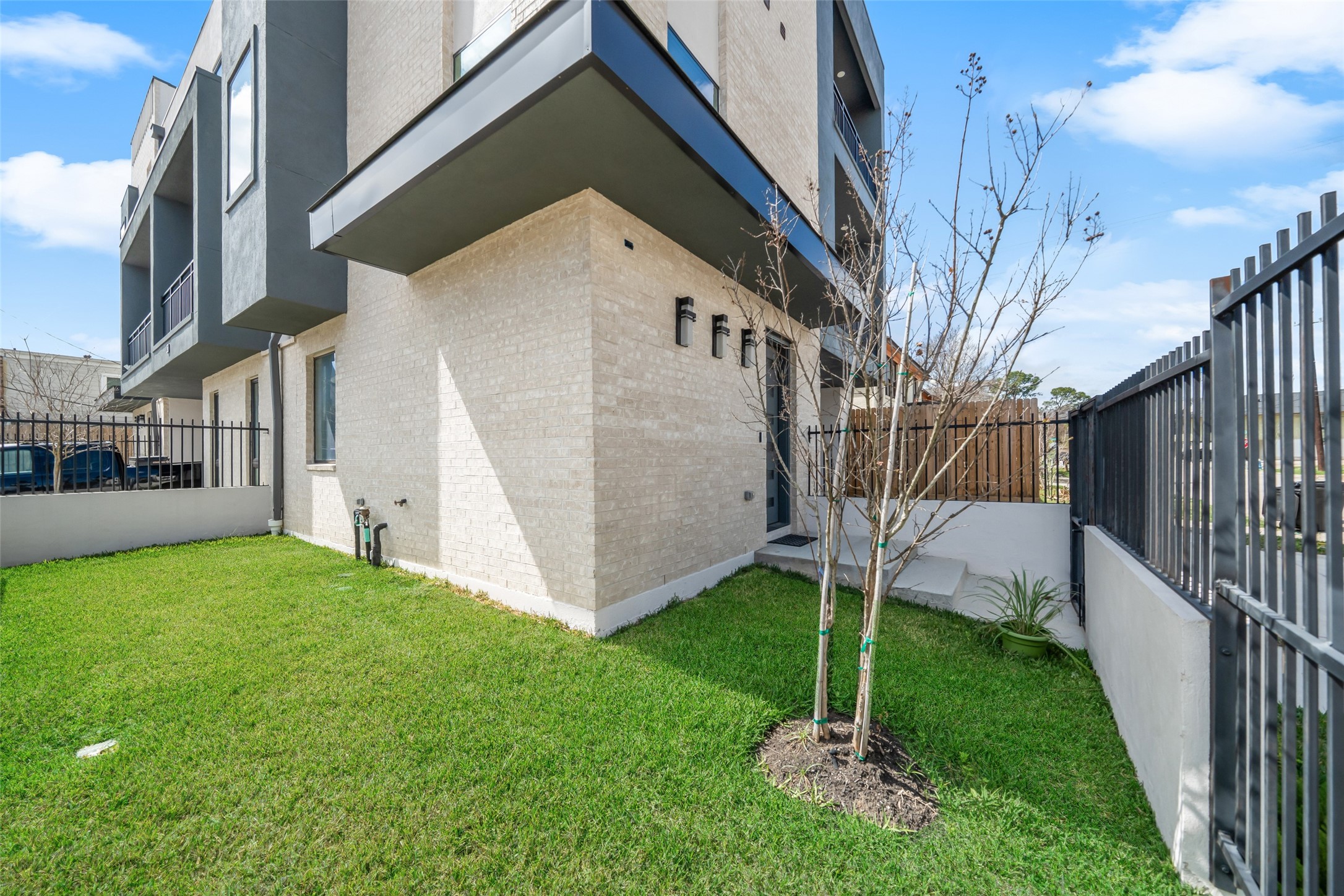 Fenced yard featuring a well-maintained lawn.