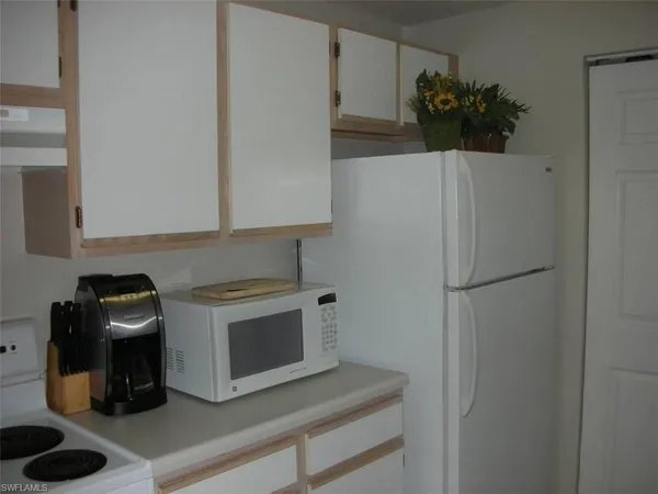 a white refrigerator freezer sitting inside of a kitchen