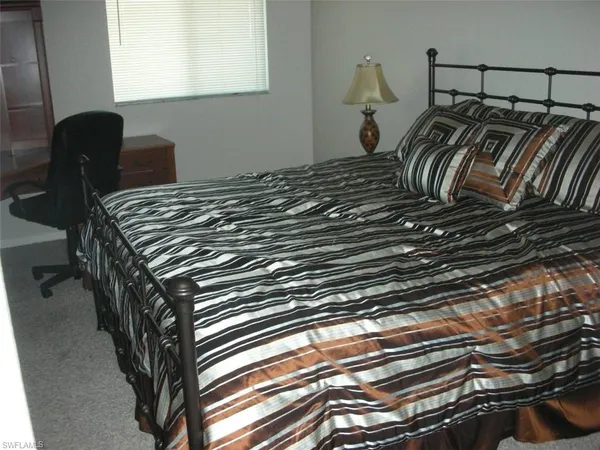 a bedroom with bed and a window