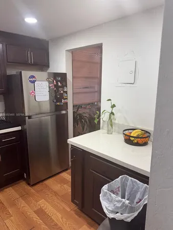 a kitchen with stainless steel appliances granite countertop a sink refrigerator and microwave