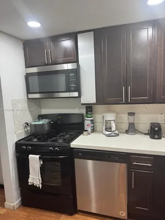 a kitchen with a sink stove and microwave