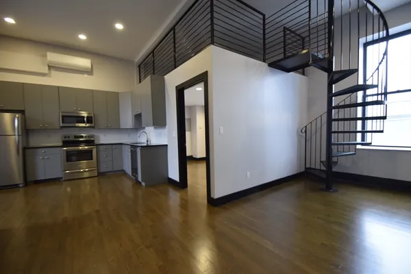 a kitchen with stainless steel appliances a refrigerator and a stove top oven