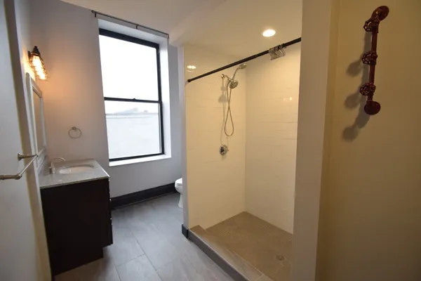 a bathroom with a shower and a sink