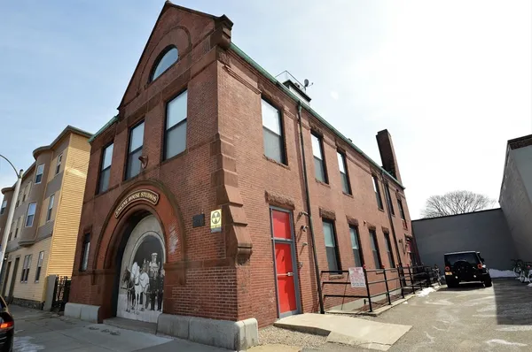 a view of a brick building with entryway windows