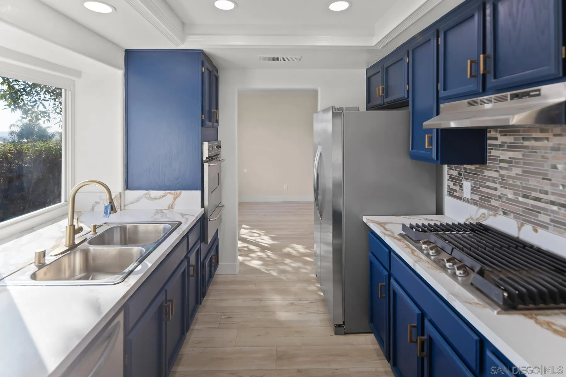 10167 Bluestone Court Spring Valley, CA 91977 - Photo 11 of 49 a kitchen with sink a stove and refrigerator